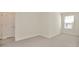 Bright, carpeted bedroom with natural light streaming through the window at 2949 Suncoast Plains Dr, Odessa, FL 33556