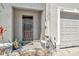 Close-up of the front door with a welcome mat and gray exterior paint at 2949 Suncoast Plains Dr, Odessa, FL 33556