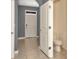 Hallway view with tile flooring, access to the bathroom, and neutral walls at 2949 Suncoast Plains Dr, Odessa, FL 33556