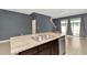 Kitchen island with double sink and view of living area at 2949 Suncoast Plains Dr, Odessa, FL 33556