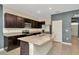 Kitchen with an island, granite countertops, stainless steel appliances, and dark cabinets at 2949 Suncoast Plains Dr, Odessa, FL 33556