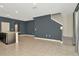 An open-concept living room with tiled floors and gray walls features an island with sink at 2949 Suncoast Plains Dr, Odessa, FL 33556