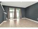 Living room with tile floors and sliding glass doors to the backyard at 2949 Suncoast Plains Dr, Odessa, FL 33556