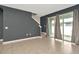 Spacious living room with staircase, tile floors, and sliding glass doors at 2949 Suncoast Plains Dr, Odessa, FL 33556