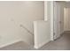 This stairwell features carpeted stairs and white walls leading to upper level at 2949 Suncoast Plains Dr, Odessa, FL 33556