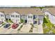 Attractive townhomes with manicured landscaping and a red car in the driveway at 2949 Suncoast Plains Dr, Odessa, FL 33556