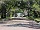 Charming tree-lined street with brick road and lush landscaping at 3021 W Lawn Ave, Tampa, FL 33611