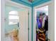 View into a bathroom area with a window and a view into a closet full of clothes at 3051 Jodi Ln, Palm Harbor, FL 34684