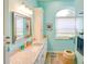 Bathroom with a large mirror over the vanity and a window view to the outside at 3051 Jodi Ln, Palm Harbor, FL 34684