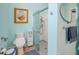 Bathroom with a shower and a bidet toilet and a round mirror on the light blue walls at 3051 Jodi Ln, Palm Harbor, FL 34684