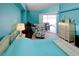 Cozy bedroom featuring soft colors, comfortable furniture, and access to outdoor area at 3051 Jodi Ln, Palm Harbor, FL 34684