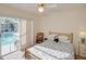 Bedroom featuring a sliding glass door with an outside view of the pool and patio at 3051 Jodi Ln, Palm Harbor, FL 34684