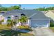 Charming single-story home featuring a two-car garage, lovely landscaping, and a welcoming front entrance at 3051 Jodi Ln, Palm Harbor, FL 34684