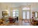 Welcoming foyer featuring lovely front door, pretty chandelier, and attractive wood-look flooring at 3051 Jodi Ln, Palm Harbor, FL 34684
