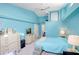 Bright blue bedroom featuring a vaulted ceiling with fan and light colored furniture at 3051 Jodi Ln, Palm Harbor, FL 34684