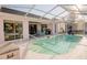 View of the screened-in pool, outdoor seating, and access to the home's interior at 3051 Jodi Ln, Palm Harbor, FL 34684