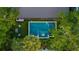 Aerial view of backyard featuring a pool, spa, outdoor kitchen, and lush landscaping at 3105 S Schiller St, Tampa, FL 33629