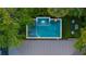 Aerial view of backyard pool and jacuzzi surrounded by lush, tropical landscaping and elegant outdoor furniture at 3105 S Schiller St, Tampa, FL 33629