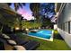 Backyard boasts a pool, spa, and lounge chairs, enhanced by an outdoor fire pit and mature landscaping at 3105 S Schiller St, Tampa, FL 33629