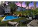 Backyard features a pool, spa, and lounge area, complemented by lush landscaping and modern design elements at 3105 S Schiller St, Tampa, FL 33629