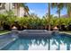 Backyard includes a pool and spa, with stylish fire bowls for ambiance, surrounded by privacy landscaping at 3105 S Schiller St, Tampa, FL 33629