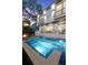 Backyard includes a pool, spa, and fire pit, perfect for outdoor relaxation and complemented by modern design at 3105 S Schiller St, Tampa, FL 33629