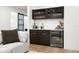Stylish wet bar with sleek cabinets, a beverage cooler, and modern finishes at 3105 S Schiller St, Tampa, FL 33629