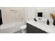Clean bathroom with shower-tub combo, modern vanity, and minimalist design at 3105 S Schiller St, Tampa, FL 33629