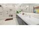 Bright, modern bathroom with large walk-in shower, floating vanity, and marble accents at 3105 S Schiller St, Tampa, FL 33629