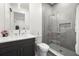 Modern bathroom featuring sleek gray tiling in the shower, a glass door, and modern fixtures and vanity at 3105 S Schiller St, Tampa, FL 33629