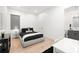 Modern bedroom with a plush bed, and wood flooring, bright neutral walls, and ensuite bathroom at 3105 S Schiller St, Tampa, FL 33629