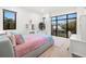 Bright bedroom features large windows, light wood floors, and a pink and blue accent bedding for a youthful vibe at 3105 S Schiller St, Tampa, FL 33629