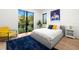 The bedroom is bright and features a large window with lots of natural light and a colorful rug at 3105 S Schiller St, Tampa, FL 33629