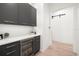 Butler's pantry featuring gray cabinets, marble countertops, and a beverage cooler at 3105 S Schiller St, Tampa, FL 33629
