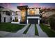 Modern two-story home featuring a striking facade, large windows, balcony, manicured lawn, and stylish curb appeal at 3105 S Schiller St, Tampa, FL 33629