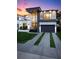 Striking modern home boasts clean lines, large windows, a two-car garage, and lush landscaping at 3105 S Schiller St, Tampa, FL 33629