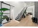 Open-concept foyer features floating stairs, natural light, and access to other living spaces at 3105 S Schiller St, Tampa, FL 33629