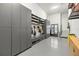 Large garage with ample storage: cabinets, shelves, hanging racks and a refrigerator at 3105 S Schiller St, Tampa, FL 33629