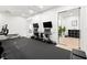 Bright home gym features mirrored walls, mounted televisions, storage cubes, and exercise equipment at 3105 S Schiller St, Tampa, FL 33629