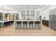 Elegant kitchen with large center island, stainless steel appliances, and seamless access to the dining area and wine storage at 3105 S Schiller St, Tampa, FL 33629