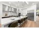 Modern kitchen boasts stainless steel appliances, a marble island with seating, and bright recessed lighting at 3105 S Schiller St, Tampa, FL 33629
