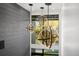 Three modern globe chandeliers hang by a large window with greenery views at 3105 S Schiller St, Tampa, FL 33629