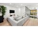 Upstairs living room showcasing a gray sectional sofa, modern lighting, and a textured accent wall at 3105 S Schiller St, Tampa, FL 33629