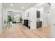 Open concept living area with hardwood floors, modern decor, and butler's pantry at 3105 S Schiller St, Tampa, FL 33629