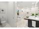 Spa-like bathroom with a soaking tub, walk-in shower, double vanity, and marble-style tiling at 3105 S Schiller St, Tampa, FL 33629