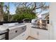 Well-equipped outdoor kitchen with built-in grill and stainless steel appliances at 3105 S Schiller St, Tampa, FL 33629