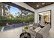 Inviting covered patio with modern furniture overlooking the pool and lush landscaping at 3105 S Schiller St, Tampa, FL 33629
