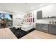 Recreation room with stylish decor, including skateboard art, a white sectional sofa, and a beverage cooler at 3105 S Schiller St, Tampa, FL 33629