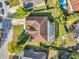 An aerial view showcasing the property's layout, including a screened-in pool, lush landscaping, and a well-maintained lawn at 3208 Stevenson St, Plant City, FL 33566