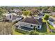 Aerial view of a home featuring a screened-in pool and well-manicured landscaping and mature trees at 3208 Stevenson St, Plant City, FL 33566